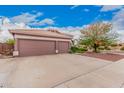 Wide driveway leads to a spacious three-car garage with desert landscaping at 5031 W Ivanhoe St, Chandler, AZ 85226