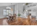 Bright dining area with hardwood floors, a staircase, and ample natural light from the large windows at 5615 W Tonopah Dr, Glendale, AZ 85308