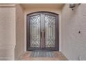 Elegant arched double front door with decorative ironwork, adding a touch of sophistication and curb appeal at 5615 W Tonopah Dr, Glendale, AZ 85308