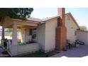 Charming home featuring a brick chimney, cozy covered porch, and a view of the extended driveway at 6212 S 12Th St, Phoenix, AZ 85042