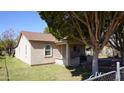 Charming exterior featuring a covered porch, newer roof, and mature shade tree at 6212 S 12Th St, Phoenix, AZ 85042