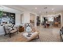 Open-concept living room showcases wood-look floors, modern furniture, and natural light at 631 E Peach Tree St, Queen Creek, AZ 85140