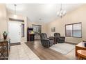 Bright living room with a classic arcade game and comfortable seating at 6829 S 58Th Ave, Laveen, AZ 85339