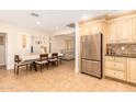 Kitchen featuring stainless steel refrigerator, tile floors, dining table, and breakfast nook at 6842 N 10Th Pl, Phoenix, AZ 85014