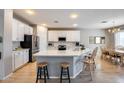 Modern kitchen with white cabinetry, stainless steel appliances, and a spacious island at 7317 W Southgate Ave, Phoenix, AZ 85043