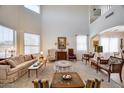 Bright living room featuring high ceilings, large windows, and tasteful decor at 7317 W Southgate Ave, Phoenix, AZ 85043