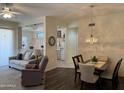 Open-concept living and dining area with a ceiling fan and neutral color palette at 7361 E Rugged Ironwood Rd, Gold Canyon, AZ 85118