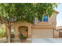 Charming two-story home with a well-manicured lawn and welcoming front porch at 7567 W Andrea Dr, Peoria, AZ 85383