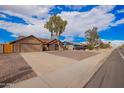 A street view shows the homes in a quiet residential neighborhood on a sunny day at 8738 W Mountain View Rd, Peoria, AZ 85345