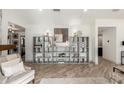 Stylish living room featuring chic decor and custom shelving creating an elegant space at 9515 N 47Th St, Phoenix, AZ 85028
