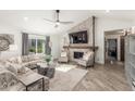 Cozy living room with a stone fireplace, vaulted ceilings, and comfortable seating at 9515 N 47Th St, Phoenix, AZ 85028
