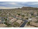 Expansive aerial view of a desert community with mountain views and community pools at 9821 E Glencove St, Mesa, AZ 85207