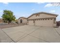 Single-story home featuring a three-car garage and low-maintenance desert landscaping at 9821 E Glencove St, Mesa, AZ 85207