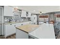 Modern kitchen with sleek cabinets, stainless appliances, and counter seating, seamlessly connected to the dining area at 10243 E Illini St, Mesa, AZ 85208