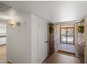 Bright entryway showcasing tile flooring, a decorative wreath, and a secure front door with a security screen at 11604 S Ki Rd, Phoenix, AZ 85044