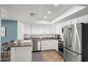 Well-lit kitchen featuring white cabinets, stainless steel appliances, and stylish countertops at 11604 S Ki Rd, Phoenix, AZ 85044