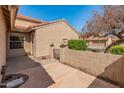 Enclosed backyard with desert landscaping, terracotta-tiled roof, and privacy wall at 13828 S 42Nd St, Phoenix, AZ 85044