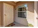 Charming entryway featuring a decorative security door, sidelight window and desert landscaping at 13828 S 42Nd St, Phoenix, AZ 85044