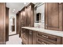 Bathroom featuring custom cabinetry with marble countertops, unique mirror and tiled flooring at 1614 W Beaubien Dr, Phoenix, AZ 85027