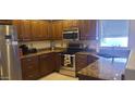 Kitchen featuring stainless steel appliances, granite countertops, and ample cabinet space at 19527 N 142Nd Dr, Sun City West, AZ 85375