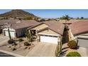 Single-Gathering home with desert landscaping, tile roof, and a two-car garage at 202 W Twin Peaks Pkwy, San Tan Valley, AZ 85143