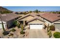 Home with tile roof, two-car garage, and desert landscaping in a neat community at 202 W Twin Peaks Pkwy, San Tan Valley, AZ 85143