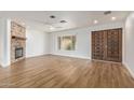 Living room with stylish flooring, a stone fireplace, and a view of the arched window and front door at 2110 E Laguna Dr, Tempe, AZ 85282