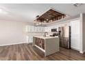 Bright kitchen with stainless steel appliances, wood island, and overhead ceiling detail at 2149 S Olivewood --, Mesa, AZ 85209