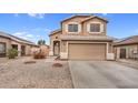 Two-story home boasting a two-car garage, beige stucco, and desert landscaping at 24848 W Kowalsky Ln, Buckeye, AZ 85326