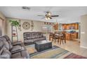 Open-concept living room seamlessly flows into dining area, showcasing natural light and modern decor at 24848 W Kowalsky Ln, Buckeye, AZ 85326