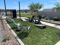 Outdoor community game area with cornhole, Adirondack chairs, and artificial turf at 2650 E Dutchmans Trl, Apache Junction, AZ 85119