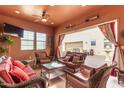 Cozy outdoor living area featuring wicker furniture, ceiling fan, and an open view, perfect for entertaining at 2830 E Janelle Way, Gilbert, AZ 85298