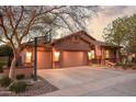 Inviting home featuring a three-car garage, a basketball hoop, and landscaped front yard at 3482 E Cotton Ln, Gilbert, AZ 85234