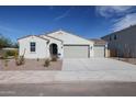 Beautiful single-story home showcasing a three car garage and low-maintenance landscaping at 35680 W Mallorca Ave, Maricopa, AZ 85138