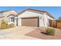 Well-maintained single-story home with desert landscaping and a paved driveway at 40160 W Hensley Way, Maricopa, AZ 85138