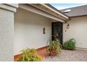 Cozy front porch with textured walls, tiled flooring, and a wrought-iron gate at 449 E Fred Ave, Apache Junction, AZ 85119