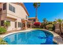 Beautiful backyard showcasing the pool, patio, and lush foliage, creating a private oasis at 4931 E Paradise Ln, Scottsdale, AZ 85254