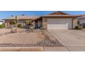 Charming single-story home with desert landscaping and a two-car garage at 5434 W Golden Ln, Glendale, AZ 85302