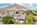 Aerial view of property showcasing pool, patio and luscious backyard at 5613 W West Wind Dr, Glendale, AZ 85310