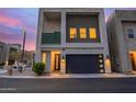 Contemporary home with a two-car garage, neutral-toned exterior, and balcony framed by modern architectural elements at 6804 E Lyra Dr, Scottsdale, AZ 85257