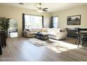 Inviting living room with a large window, neutral decor, hardwood flooring, and a comfortable seating area at 6904 W Josac St, Glendale, AZ 85308