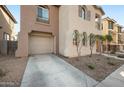 Two-story home with an attached one-car garage and concrete driveway at 7741 W Giles Rd, Phoenix, AZ 85035