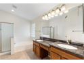Double sink bathroom with a separate bathtub and shower at 7910 W Adobe Dr, Glendale, AZ 85308