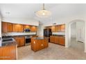 Kitchen with an island, stainless appliances and pendant lighting at 7910 W Adobe Dr, Glendale, AZ 85308