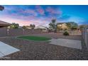 Spacious backyard featuring gravel landscaping, a small turfed area, and block wall fencing for added privacy at 8005 S 69Th Ln, Laveen, AZ 85339