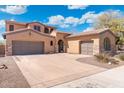 Beautiful home featuring a tile roof, big driveway, and a three-car garage, under a gorgeous blue sky at 8432 S 21St Pl, Phoenix, AZ 85042