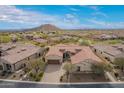 This is an aerial view of the house with a beautiful mountain view in the background at 9041 E Ivyglen Cir, Mesa, AZ 85207