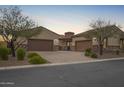 Beautiful single-Gathering home with desert landscaping, stone accents and a three-car garage at 9041 E Ivyglen Cir, Mesa, AZ 85207