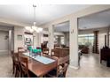 Spacious dining room with tile flooring, statement lighting, and an open floor plan at 9286 W Buckhorn Trl, Peoria, AZ 85383