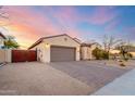 This house features low-maintenance desert landscaping with a paver driveway and a two-car garage at 9286 W Buckhorn Trl, Peoria, AZ 85383